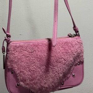Coach Small Rhyder Pochette in Pink Shearling and Pebbled Leather.